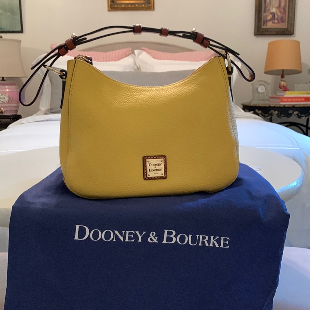 Dooney & Bourke yellow small hobo. Never carried. Dust bag.